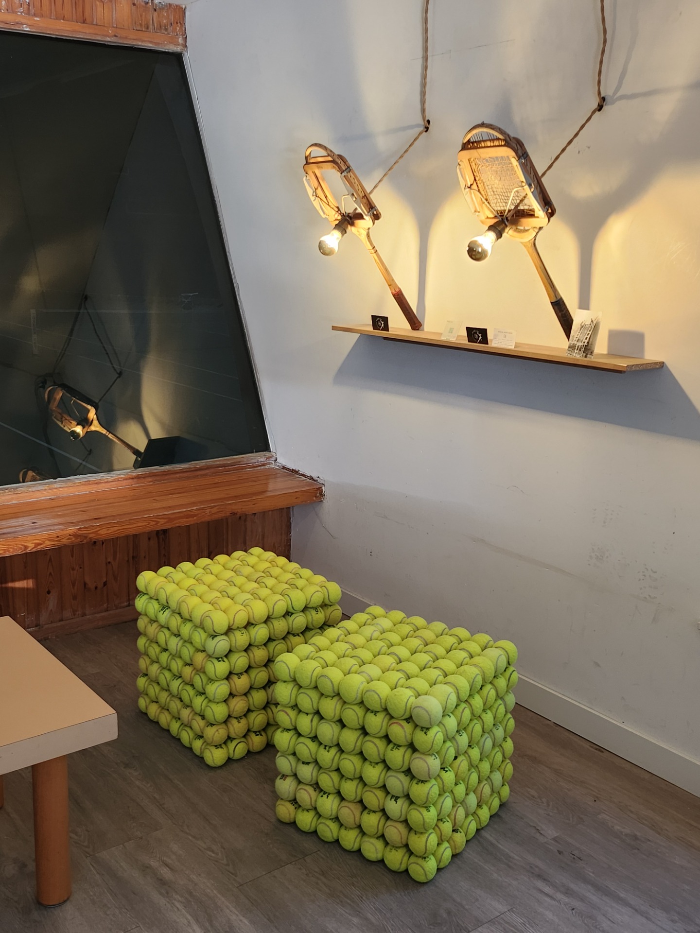 The777 - handmade pouf of 100% recycled tennis balls. The Racket lamps were made by me as well